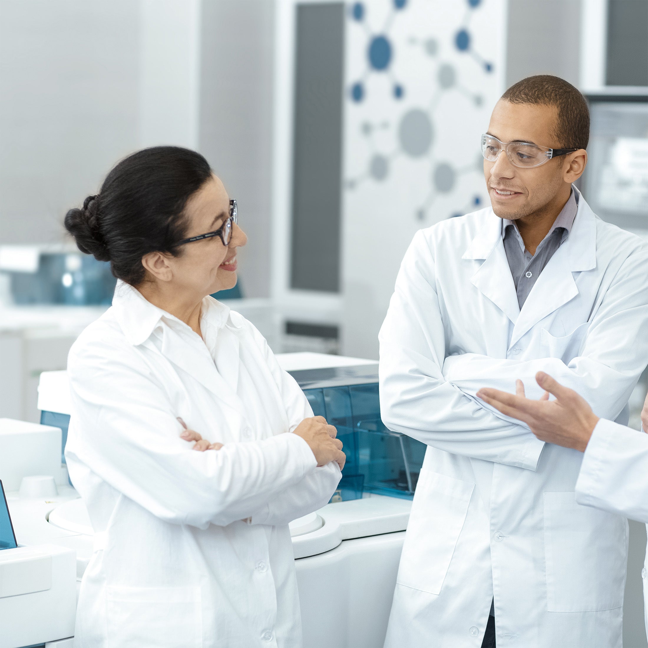 Two scientists in a laboratory setting, discussing.